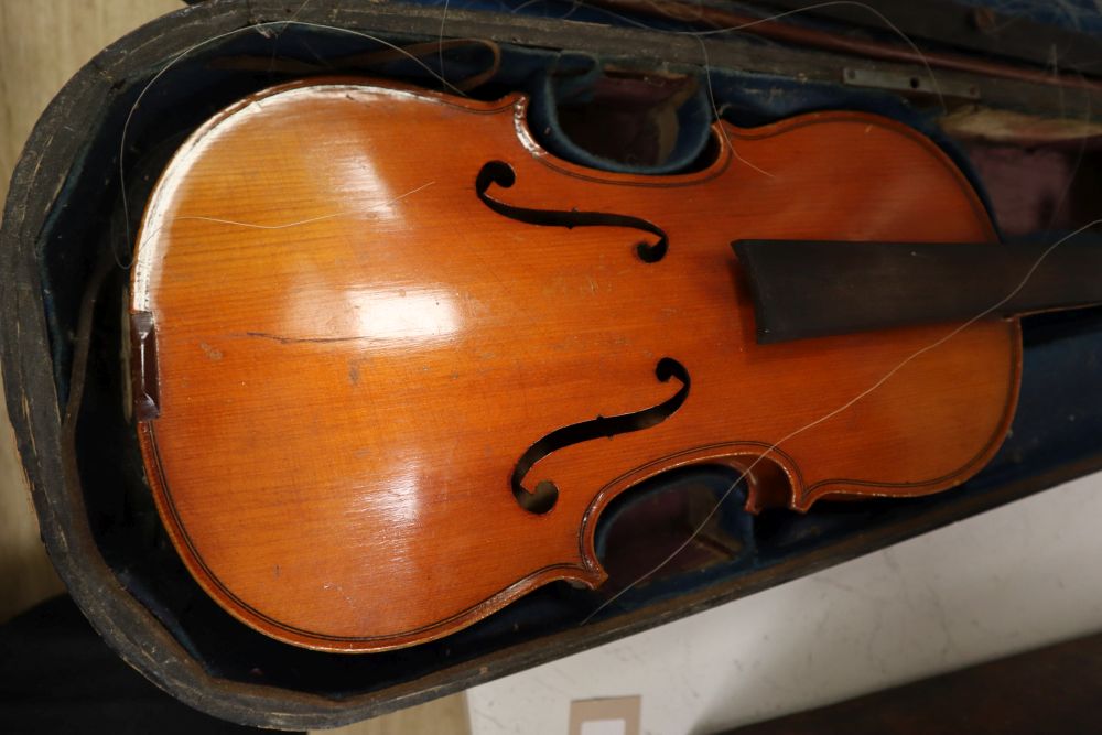 A French 3/4 size violin, Stradivarius label, with bow and accessories, in a case